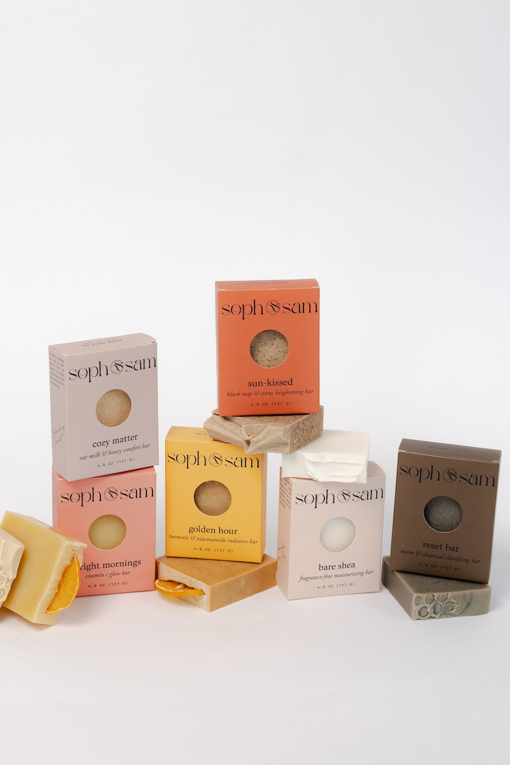 Collection of soph&sam soap bars and boxes on a white background