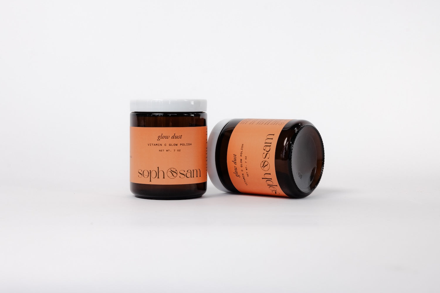 Two jars with orange labels on a white background
