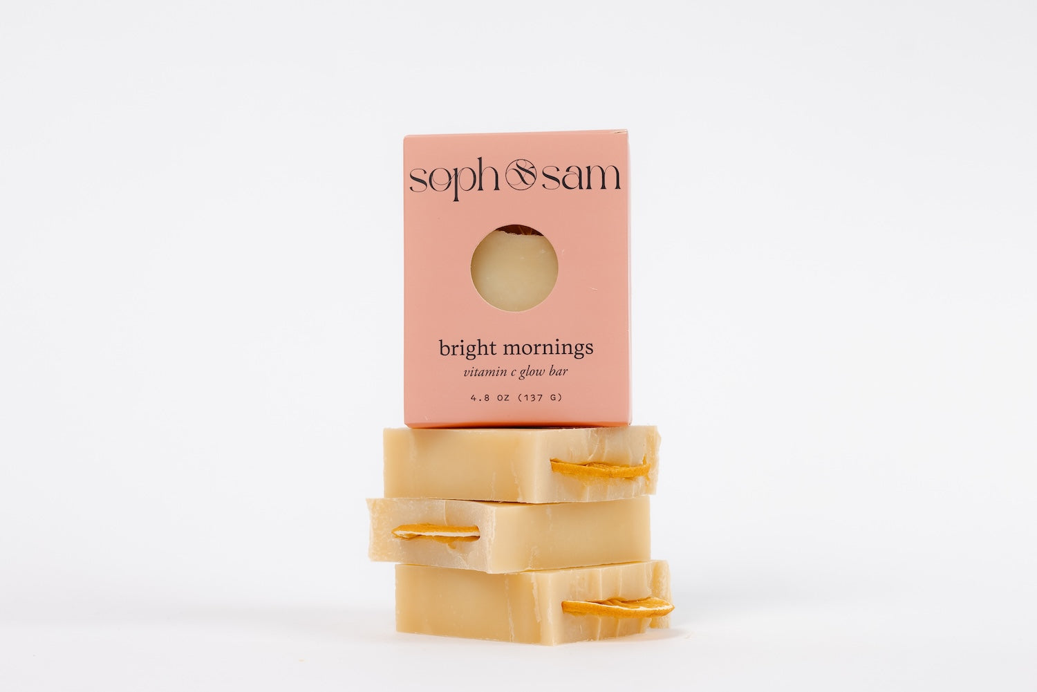 Two soap bars with a pink packaging labeled 'soph & sam' on a white background